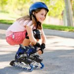 Young girl outdoors on inline skates smiling